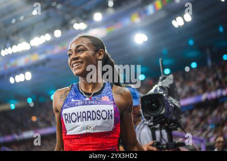 Sha'Carri Richardson celebrating her medal with her country's flag at the Paris 2024 Olympic Games. Stock Photo