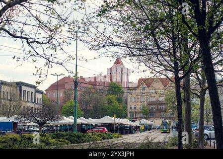 Cityscape of Poznań featuring historic buildings and a tram, capturing the blend of old and modern in the city Stock Photo