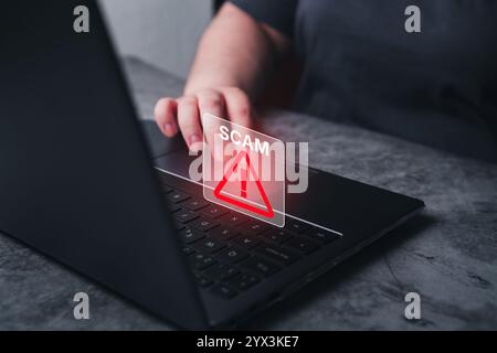Fraudulent online concept. Woman receives alert scam notification on laptop. Security information data protect. Stock Photo