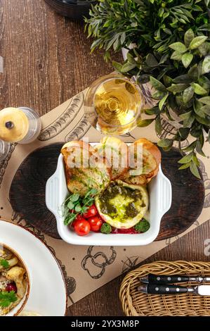 baked camembert with pesto sauce and croutons Stock Photo