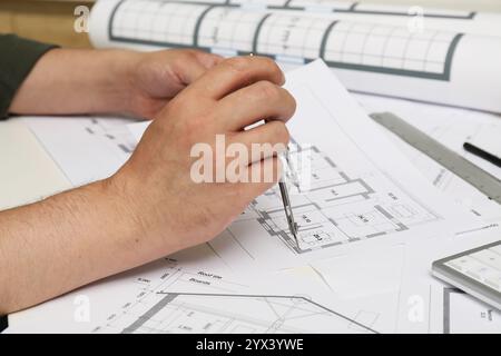 Architect working with project, closeup. Different technical drawings on table Stock Photo