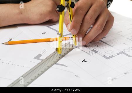 Architect working with project, closeup. Different technical drawings on table Stock Photo