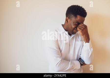 Portrait of young businessman who is tired and having headache. Stock Photo
