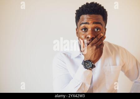 Portrait of young businessman who is shocked. Stock Photo