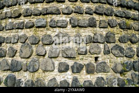 Stone surface of the wall of an ancient tower. Stock Photo