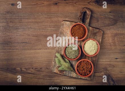 Georgian spices, in ceramic bowls, assortment, set of spices, utsho, adjika, Svan salt, ground coriander, top view, no people Stock Photo