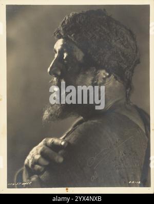 Otis Skinner, about 1931. Profile portrait of a man, Otis Skinner, in costume, wearing a cloth cap and sporting a beard. This is likely his character from the 1931 movie, "Kismet", which is set in Baghdad. Stock Photo