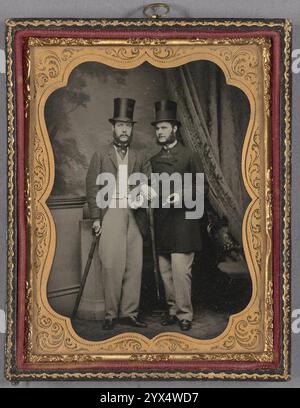 Portrait of Two Unidentified Bearded Men, about 1860.  Additional Info: This is a full-length portrait of these men. Both are wearing top hats and carrying umbrellas. The men have their arms hooked; one is holding a cigar. the backdrop is somewhat elaborate. Stock Photo