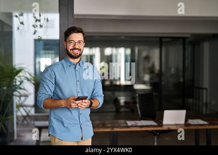 Happy professional Latin young business man looking at camera at work, portrait. Stock Photo