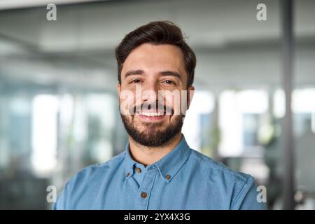 Happy professional Latin business man looking at camera at work, portrait. Stock Photo