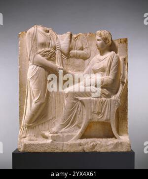 Grave Naiskos of a Seated Woman with Two Standing Women, about 340 BC.  Additional Info: Three women fill this naiskos, or small funerary shrine. The arrangement of the figures is fairly standard for such monuments in the mid 300s BC At the right, a seated woman reaches out and shakes hands with a woman standing at the left. The handshake was a frequent gesture on Greek grave monuments of this time, symbolizing a continuing connection between the deceased and living family members. The third woman, carved in low relief in the background, probably once held her hand to her cheek in a gesture of Stock Photo