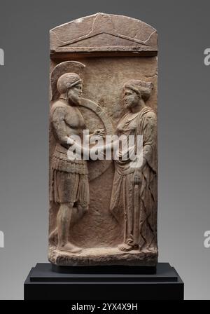 Grave Stele of Philoxenos with his Wife, Philoumene, about 400 BC. Gravestone of Philoxenos and Philoumene.  Additional Info: Philoxenos, wearing the armor of a warrior, stands before his wife Philomene, clasping her hand, on this stele (gravestone) from Athens. The figures were originally elaborated with painted details. A Greek inscription engraved above them identifies the couple. The handshake motif, or dexiosis, was a symbolic gesture that could represent a simple farewell, a reunion in the afterlife, or an ongoing connection between the deceased and the living. It is often difficult to t Stock Photo