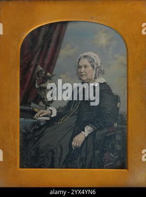 Portrait of a Seated Elderly Woman, 1852-1855. The woman is next to a table with vase and books. Stock Photo