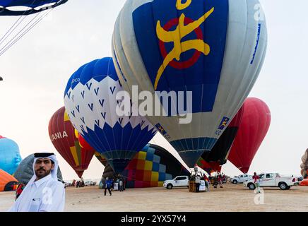 Doha, Qatar. 13th Dec, 2024. People look at hot air balloons taking off during the Qatar Balloon Festival 2024 in Doha, Qatar, on December 13, 2024. The 5th Edition of the Qatar Balloon Festival takes place here from December 12 to 22, and more than 50 participants participate in the festival (Photo by Noushad Thekkayil/NurPhoto). Credit: NurPhoto SRL/Alamy Live News Stock Photo