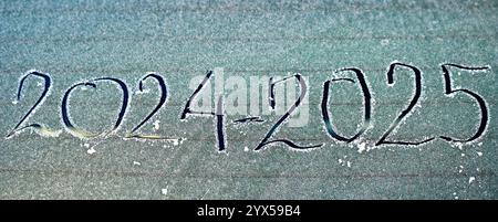 handwritten number 2025 on a frost of car window. Stock Photo