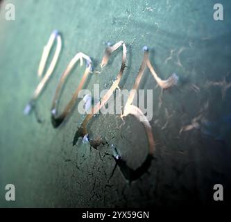 handwritten number 2025 on a frost of car window. Stock Photo