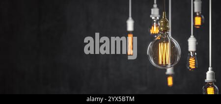 Retro edison style lightbulbs with visible filaments dark background 3d Stock Photo