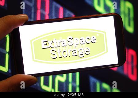 In this photo illustration, the Extra Space Storage company logo is seen displayed on a smartphone screen. Stock Photo