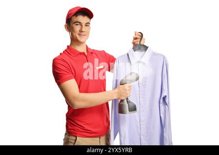 Dry clean worker ironing a shirt with a hand steam iron isolated on white background Stock Photo