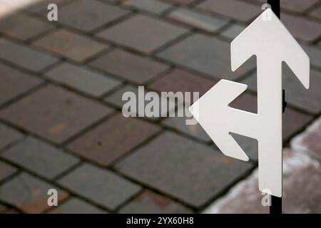 A sidewalk arrow sign indicating the direction Stock Photo