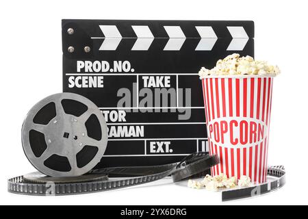 Movie clapper with film reels and popcorn on white background Stock Photo