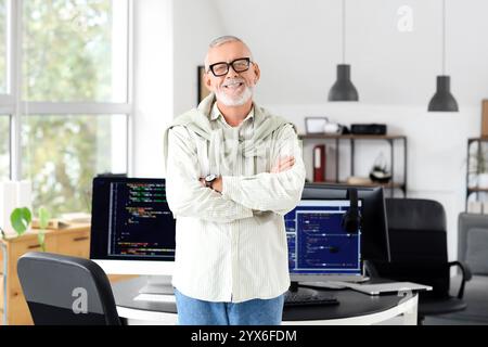 Portrait of mature programmer in office Stock Photo