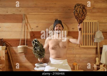 Handsome man with whisks in sauna Stock Photo