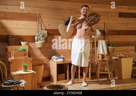 Handsome man with felt hat and whisk in sauna Stock Photo