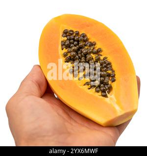 Peeled Pepaya or papaya fruit. Cut out papaya. Half of papaya. Papaya a large oval fruit with a yellowish skin and sweet orange flesh. Stock Photo