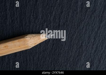 Closeup wooden pencil on black background. Top view Stock Photo