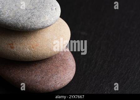 Stack of pebbles on black stone background. Zen concept Stock Photo
