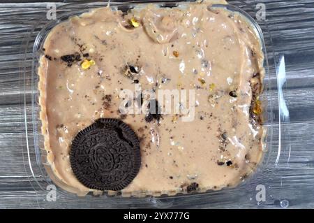 Creamy cold cookie pieces with a sweet fondant filling with whipped cream and chocolate ice cream, with pieces of cocoa biscuits, summertime and holid Stock Photo