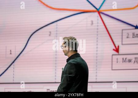 Professional presenter discussing growth trends and data interpretations, emphasizing visual analytics and decision-making processes. Stock Photo