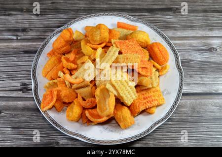 Traditional savory snacks mix, with assorted flavors of ketchup, salt, sweet chili, crackers mixture, assorted snack with various shapes and flavor, s Stock Photo