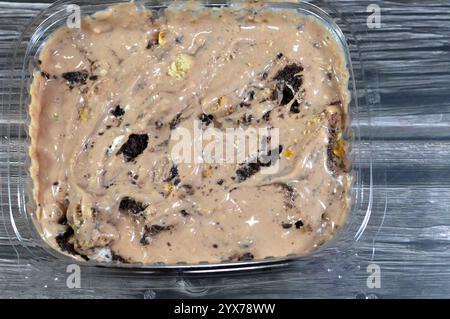 Creamy cold cookie pieces with a sweet fondant filling with whipped cream and chocolate ice cream, with pieces of cocoa biscuits, summertime and holid Stock Photo