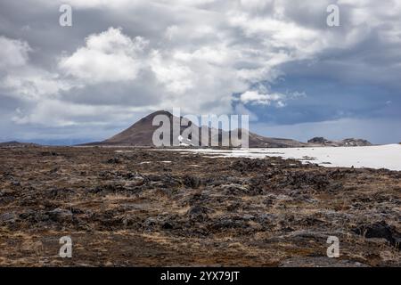 Volcanic landscape of Leirhnjukur, volcano, Myvatn Geothermal Area in Iceland, with hills and lava fields covered with moss and snow. Stock Photo