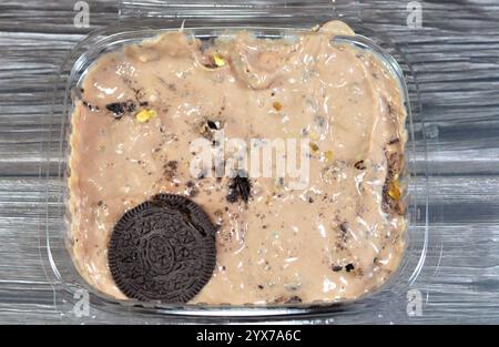 Creamy cold cookie pieces with a sweet fondant filling with whipped cream and chocolate ice cream, with pieces of cocoa biscuits, summertime and holid Stock Photo