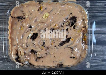 Creamy cold cookie pieces with a sweet fondant filling with whipped cream and chocolate ice cream, with pieces of cocoa biscuits, summertime and holid Stock Photo