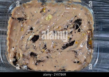 Creamy cold cookie pieces with a sweet fondant filling with whipped cream and chocolate ice cream, with pieces of cocoa biscuits, summertime and holid Stock Photo