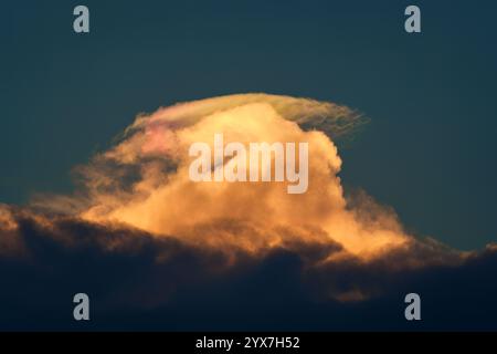 Colorful cumulus cloud formation with ray in the sunset Stock Photo