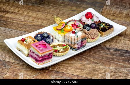 Various delicious fruit cakes on white plate on a table Stock Photo