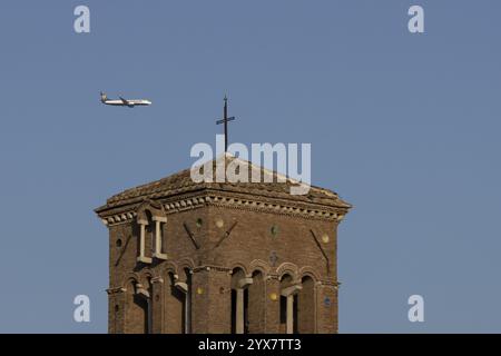 Boeing 737 jet passenger aircraft of Ryanair flying in a blue sky over an ancient city building, Rome, Italy, Europe Stock Photo