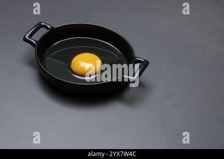 Cracked egg in a pan, hen's egg Stock Photo