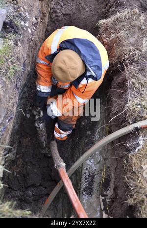 Technician connects drill head and fibre optic cable Stock Photo