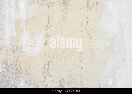 Textured plaster wall surface with peeling paint in various shades of beige and white color. Aged, weathered background. Wallpaper, backdrop, design e Stock Photo