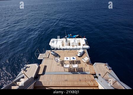 Luxury Yacht Swimming Deck Overlooking a Calm Sea with a Docked Inflatable Boat and JetSki Stock Photo