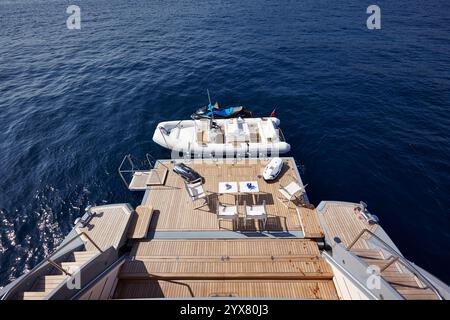 Luxury Yacht Swimming Deck Overlooking a Calm Sea with a Docked Inflatable Boat and JetSki Stock Photo