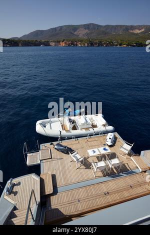 Luxury Yacht Swimming Deck Overlooking a Calm Sea with a Docked Inflatable Boat and JetSki Stock Photo