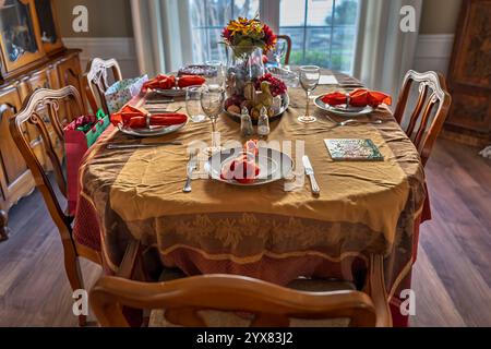 A warmly decorated dining room set for a holiday meal with family. Stock Photo