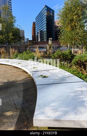 The CitySuites apartment block, Salford, from the Glade of Light Memorial Garden, Manchester, England, UK. Stock Photo